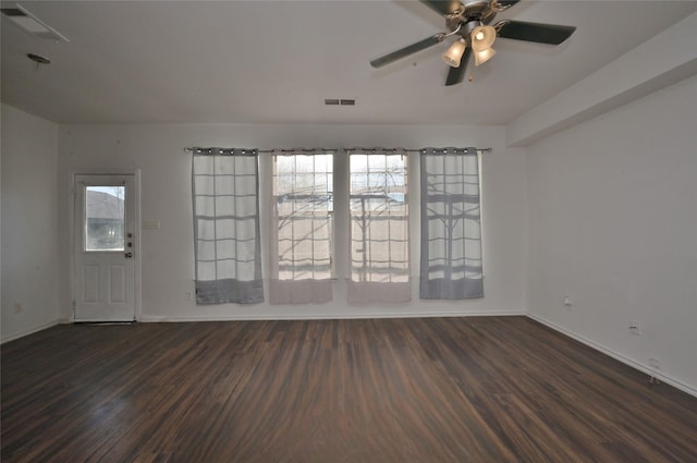 unfurnished room with ceiling fan and dark hardwood / wood-style flooring