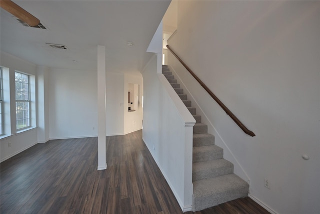 stairs featuring wood-type flooring