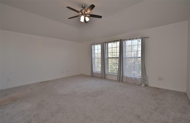 carpeted spare room with ceiling fan and lofted ceiling