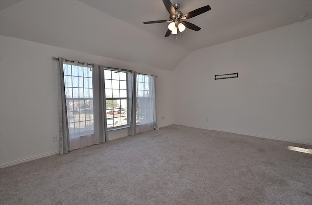 spare room featuring carpet flooring, ceiling fan, and vaulted ceiling