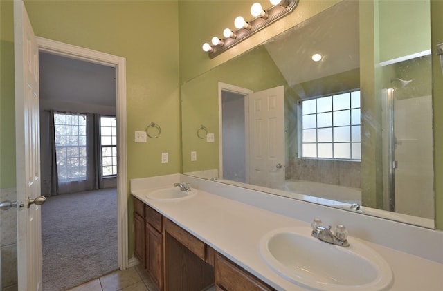 bathroom with tile patterned floors, vanity, lofted ceiling, and independent shower and bath