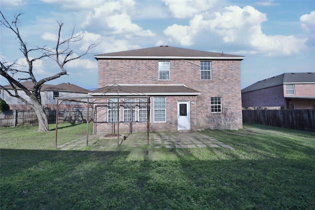 rear view of house with a gazebo and a yard