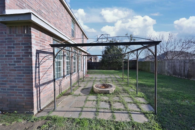 view of patio / terrace featuring an outdoor fire pit