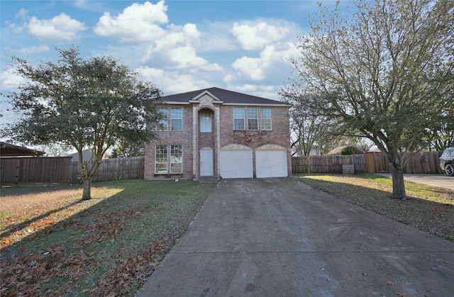 view of front of property featuring a front yard and a garage