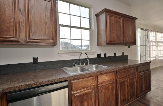 kitchen featuring stainless steel dishwasher, dark hardwood / wood-style flooring, and sink