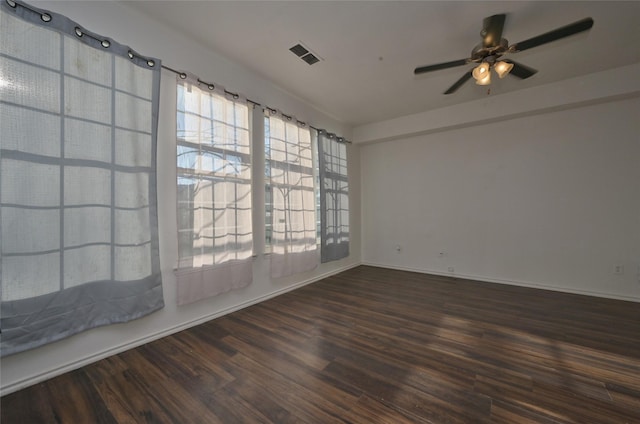 empty room featuring ceiling fan and dark hardwood / wood-style flooring