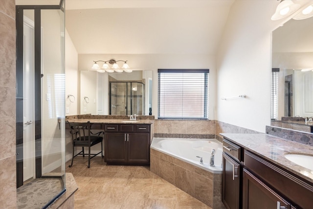 bathroom featuring vanity, shower with separate bathtub, and vaulted ceiling