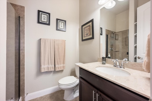 bathroom featuring tile patterned flooring, vanity, toilet, and walk in shower