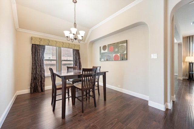 dining room with dark hardwood / wood-style flooring, vaulted ceiling, an inviting chandelier, and crown molding