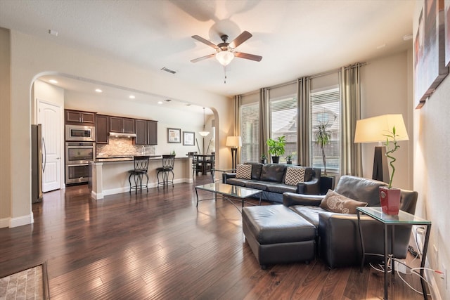 living room featuring dark hardwood / wood-style floors and ceiling fan