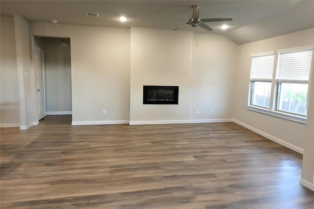 unfurnished living room with ceiling fan, lofted ceiling, and dark hardwood / wood-style flooring