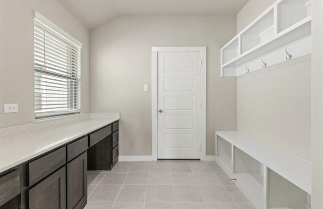 mudroom with lofted ceiling and light tile patterned floors