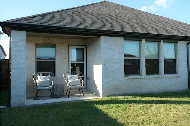 rear view of property with a yard