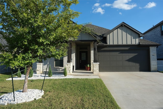 view of front of home with a garage and a front lawn