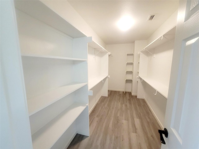 walk in closet featuring visible vents and light wood-style floors