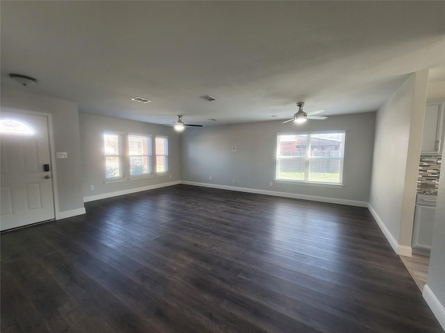 unfurnished living room featuring ceiling fan and dark hardwood / wood-style floors