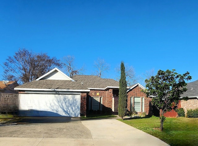 ranch-style home with driveway, a shingled roof, an attached garage, a front lawn, and brick siding