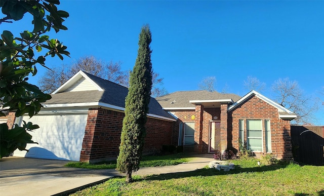 view of front of property with a front yard and a garage