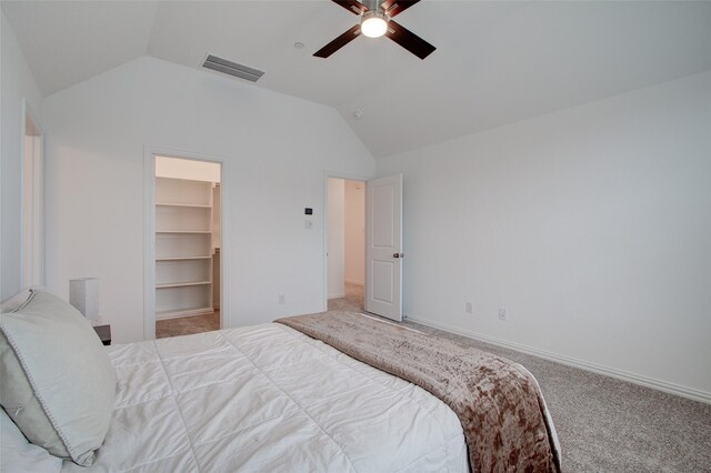 bedroom with lofted ceiling, ceiling fan, a spacious closet, carpet floors, and a closet