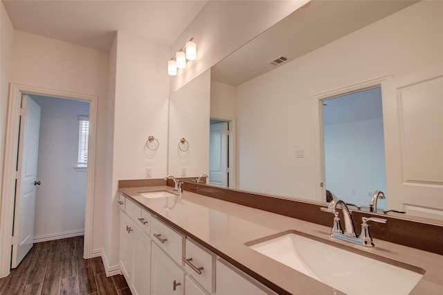 bathroom with hardwood / wood-style flooring and vanity