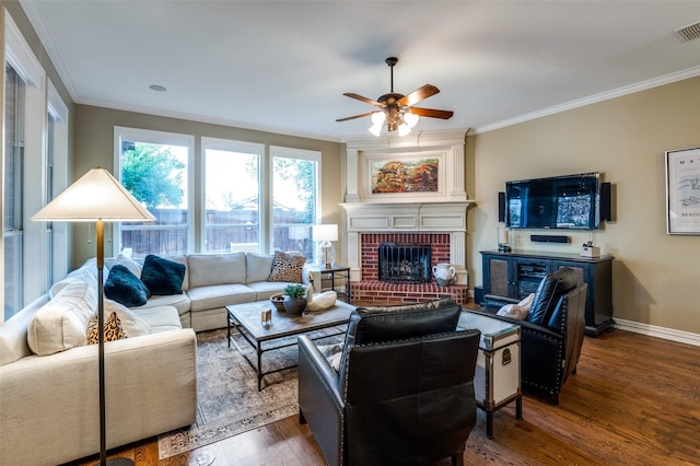 living room with a wealth of natural light, dark wood-type flooring, and ornamental molding