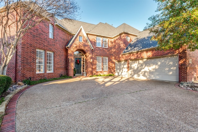 tudor-style house featuring a garage