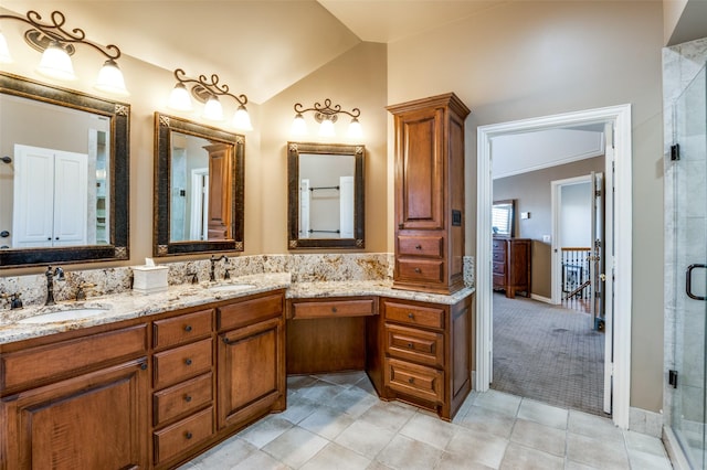 bathroom with vanity, lofted ceiling, and walk in shower