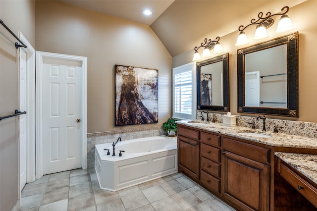 bathroom featuring a bathing tub, vanity, and lofted ceiling