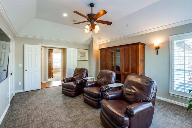 living area featuring plenty of natural light, dark carpet, ceiling fan, and lofted ceiling