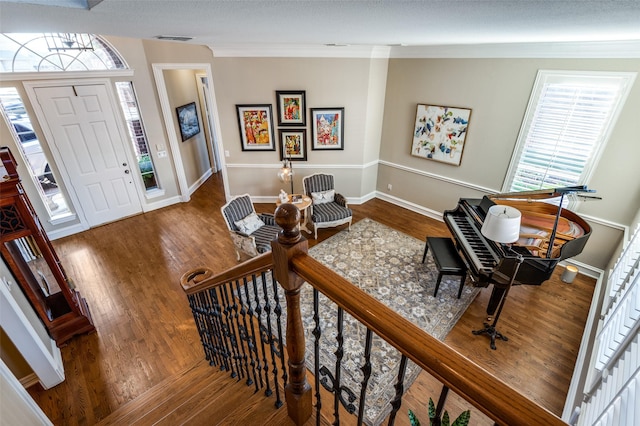 foyer with crown molding and hardwood / wood-style flooring