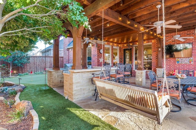 view of patio with area for grilling and ceiling fan