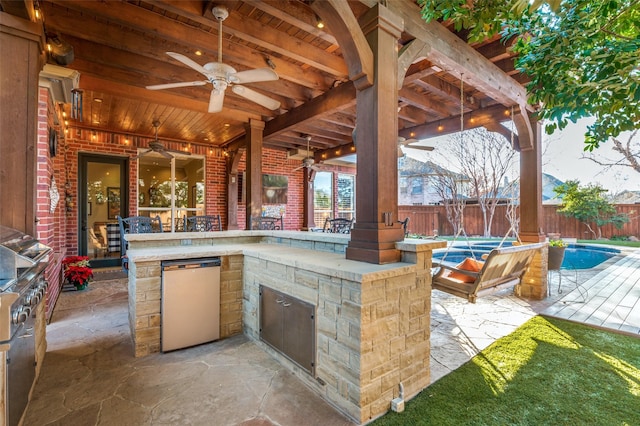 view of patio / terrace with a fenced in pool, an outdoor bar, and ceiling fan