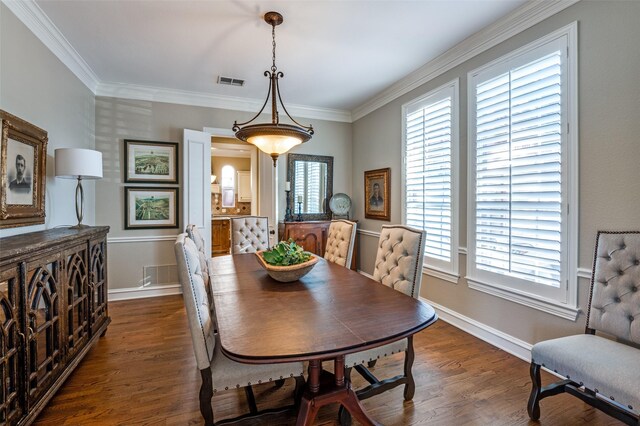 dining space with dark wood-type flooring and ornamental molding