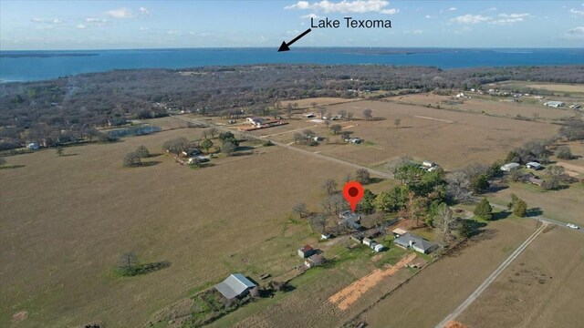 birds eye view of property featuring a rural view and a water view