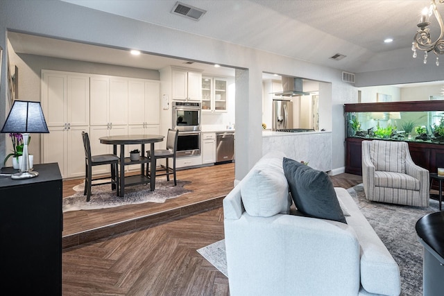 living room featuring a textured ceiling, parquet floors, and lofted ceiling