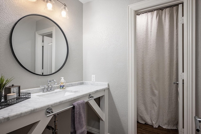 bathroom with vanity and wood-type flooring