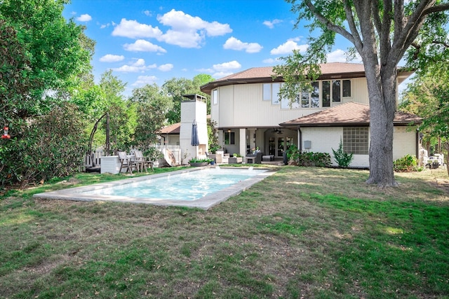 back of property featuring a patio area, ceiling fan, a yard, and outdoor lounge area