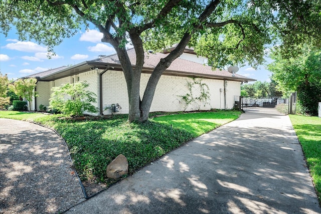 view of side of property with a lawn