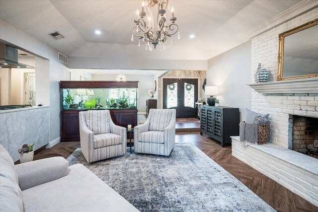 living room featuring dark parquet flooring, french doors, a brick fireplace, a textured ceiling, and a notable chandelier