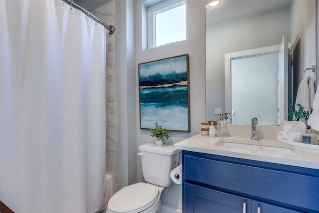 full bathroom featuring vanity, shower / tub combo, and toilet