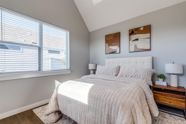 bedroom featuring hardwood / wood-style floors and vaulted ceiling