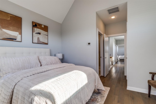 bedroom with dark hardwood / wood-style flooring and lofted ceiling