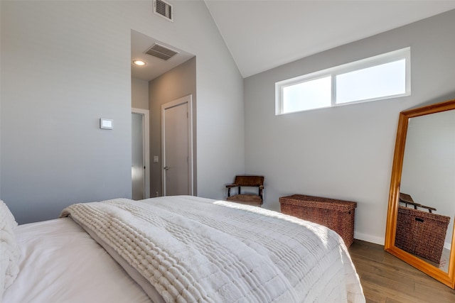 bedroom featuring lofted ceiling and light wood-type flooring