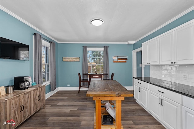 kitchen featuring white cabinetry, dark wood-type flooring, crown molding, and decorative backsplash