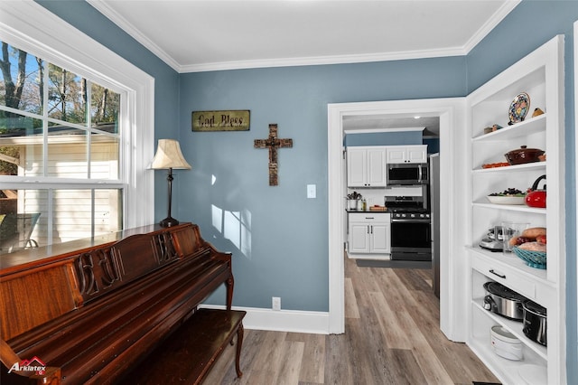 miscellaneous room with ornamental molding and light wood-type flooring