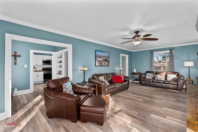 living room featuring ornamental molding, light hardwood / wood-style floors, and ceiling fan