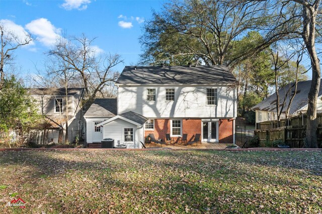 rear view of property with french doors, a yard, and central air condition unit