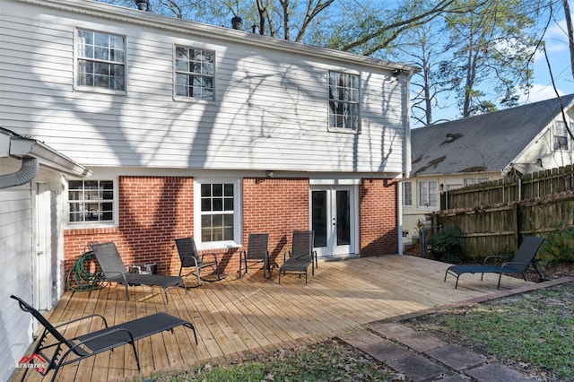 back of property featuring a wooden deck and french doors