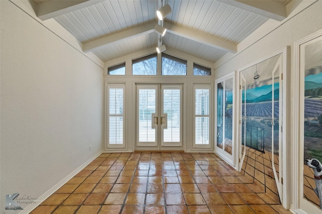 unfurnished sunroom featuring french doors and lofted ceiling with beams