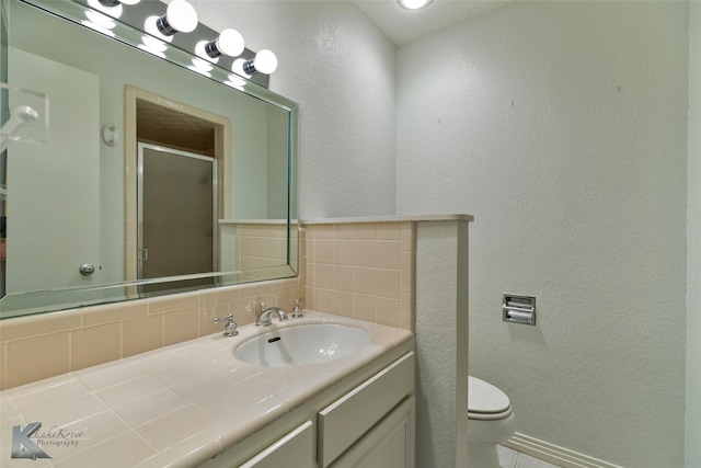 bathroom with vanity, toilet, and walk in shower